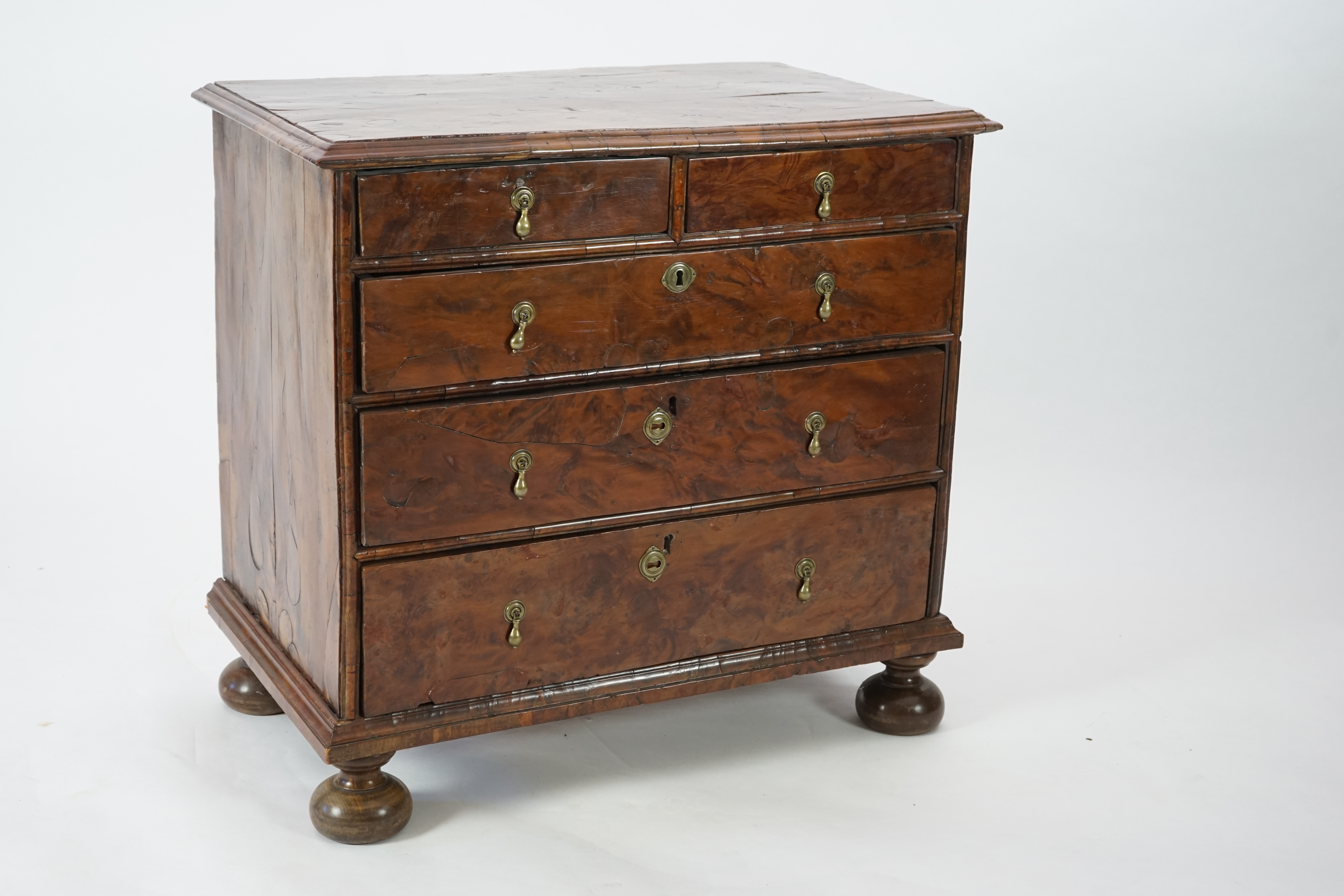 An early 18th century and later yew wood veneered oak chest